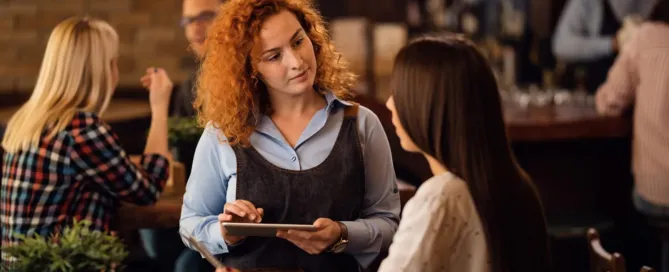 Blogartikel Titelbild: eine weibliche Bedienung nimmt eine Bestellung auf